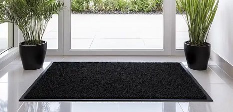 Black color door mat in front of door